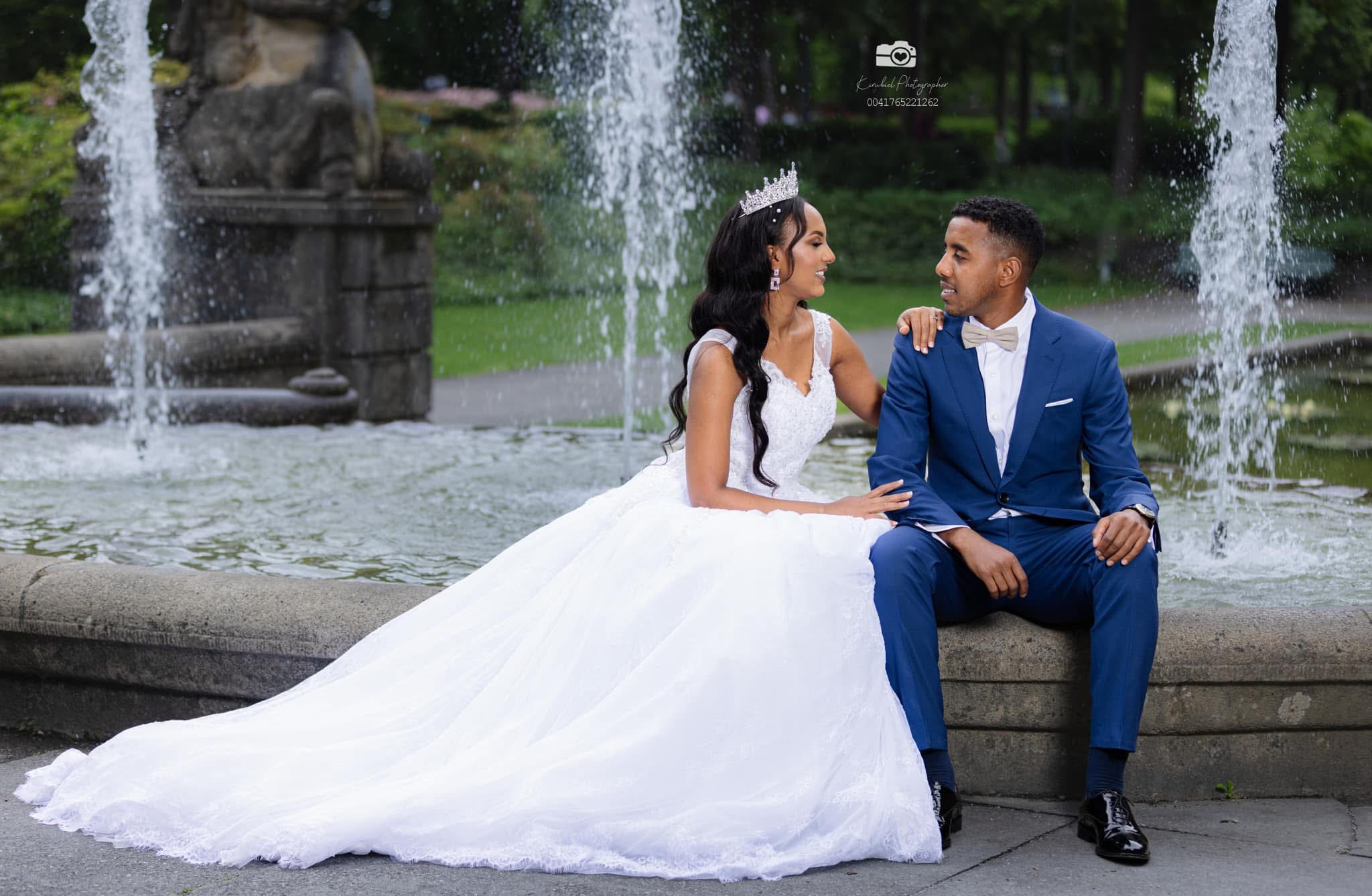 Bride and groom by fountain