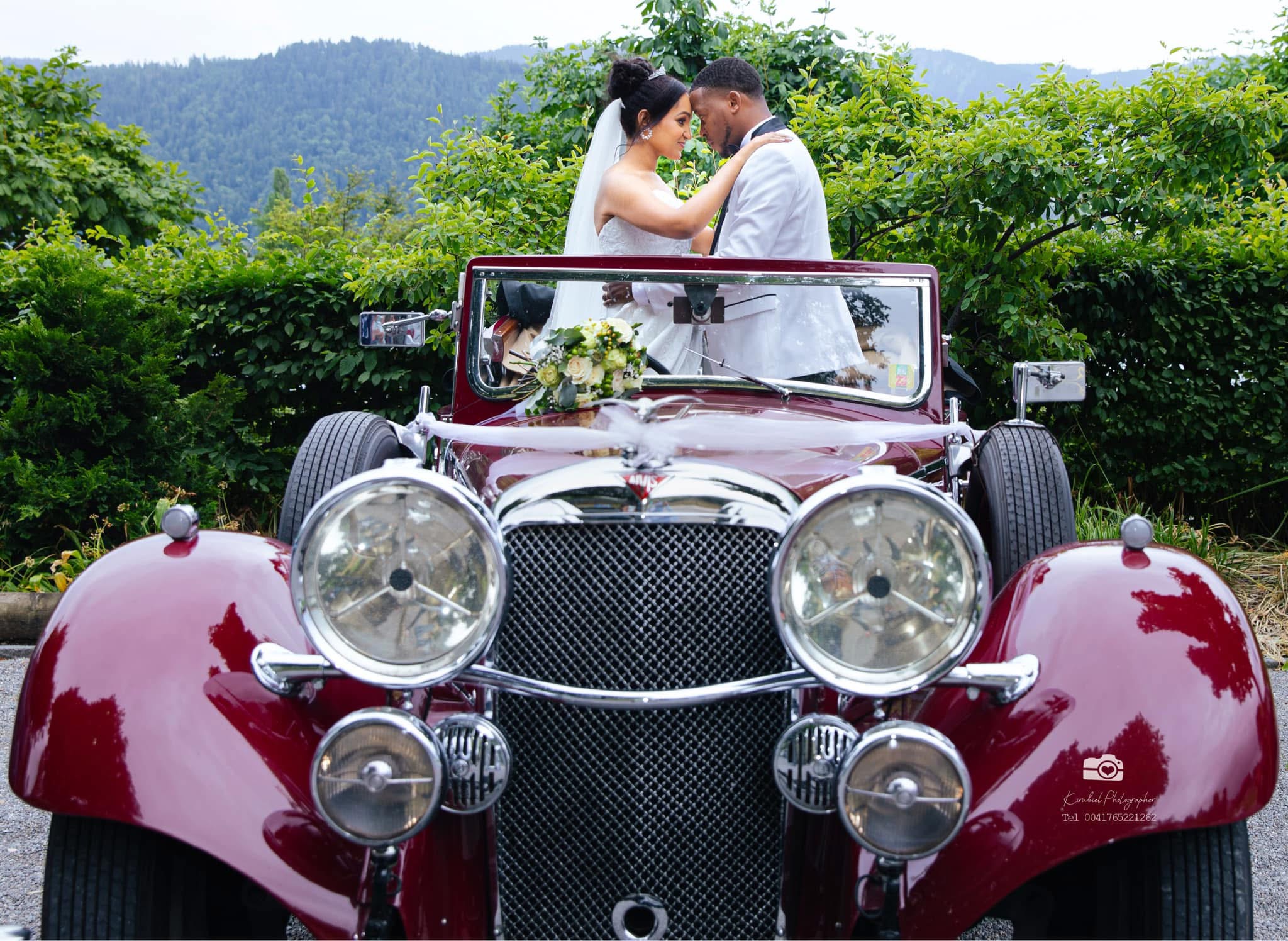 Bride and groom with luxury vintage red car